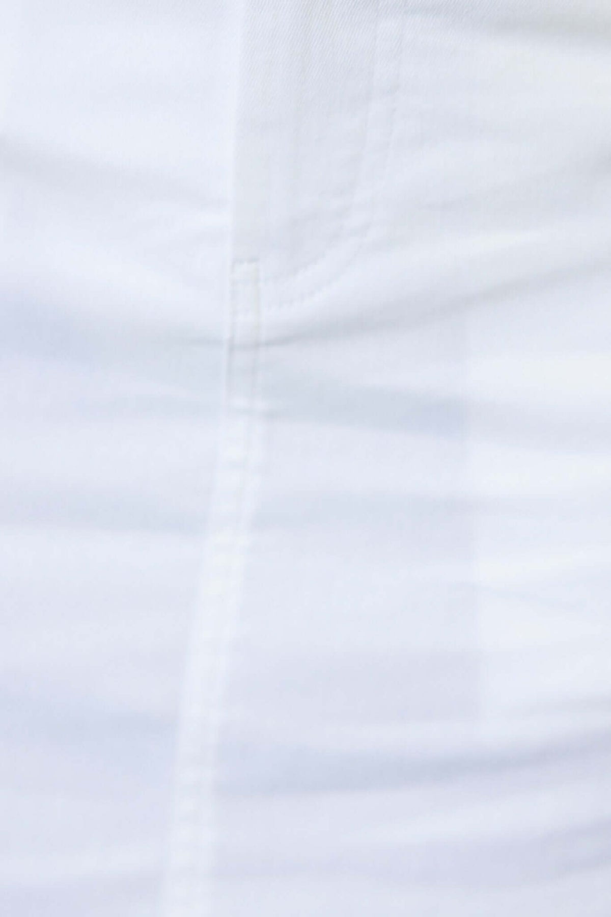 Close-up of a white midi skirt fabric, showing texture and stitching details, perfect for casual and stylish looks.