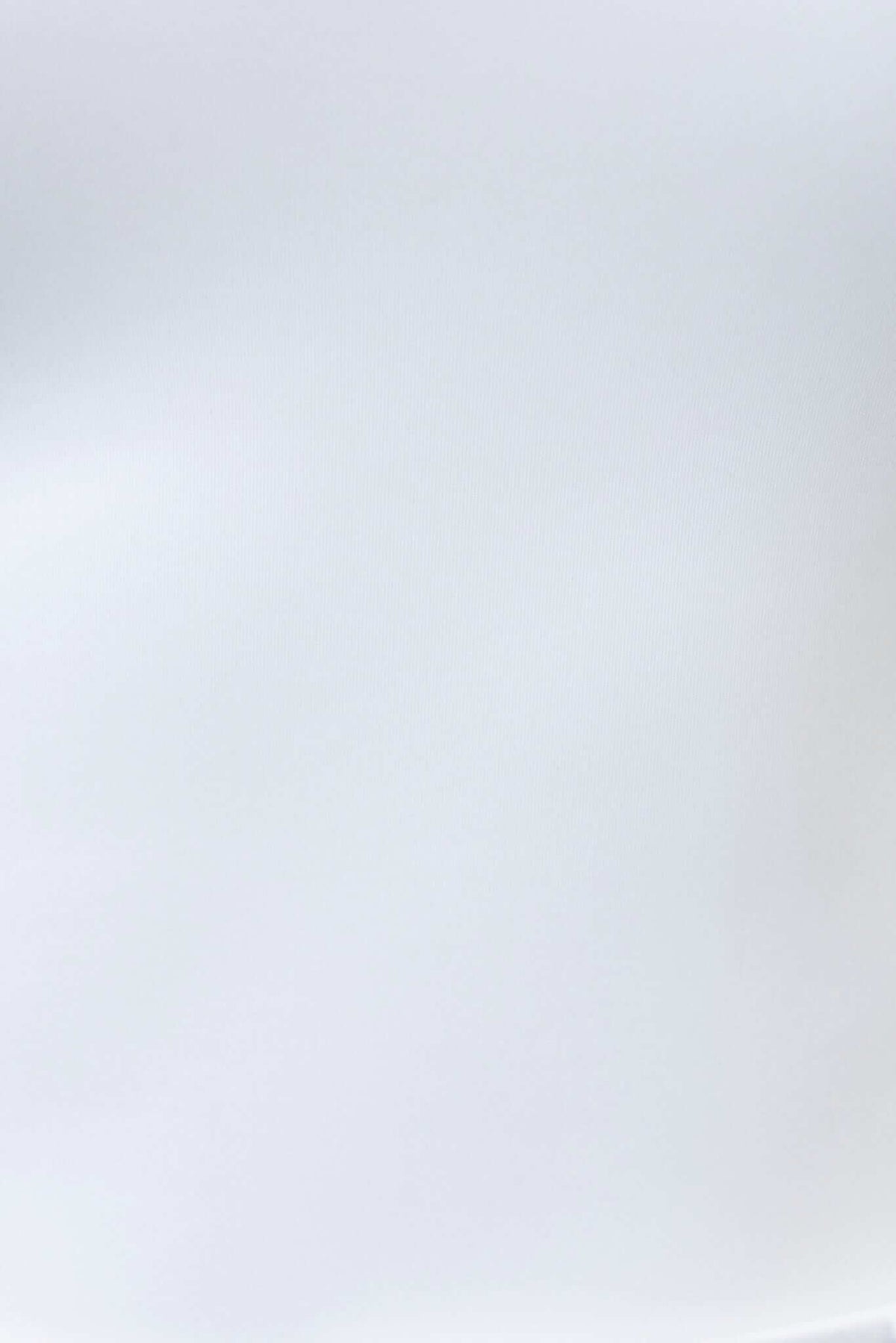 Smooth, neutral background texture suitable for product display or fashion imagery.