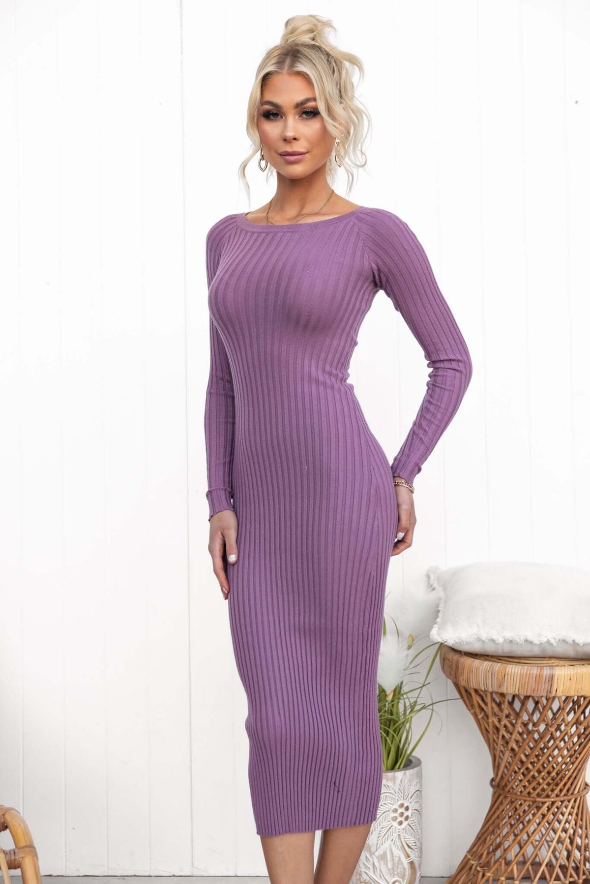 Taylah in a purple ribbed knit midi dress with a round neckline and long sleeves, showcasing a standard fit.