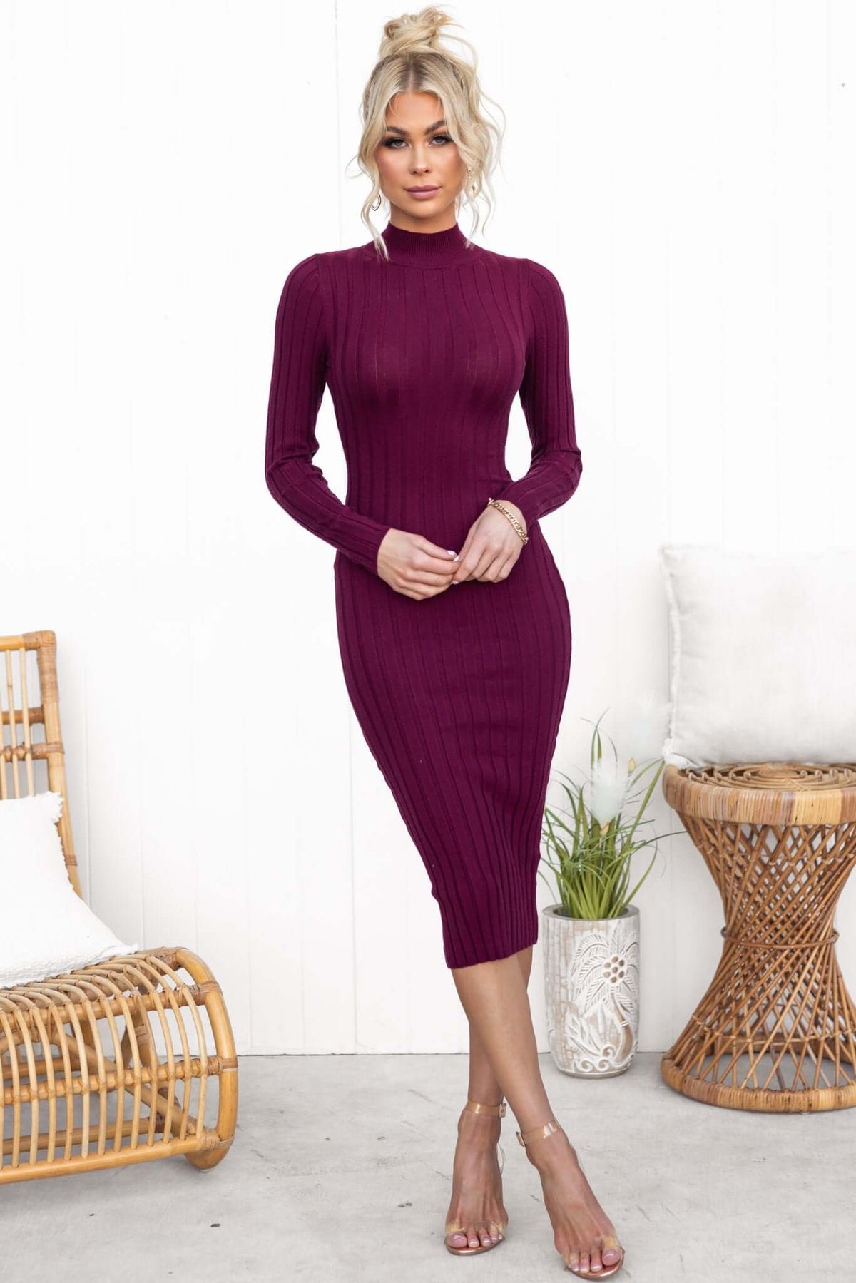 Model wearing a Bonners Midi Dress in burgundy, showcasing a high neckline and ribbed knit design.