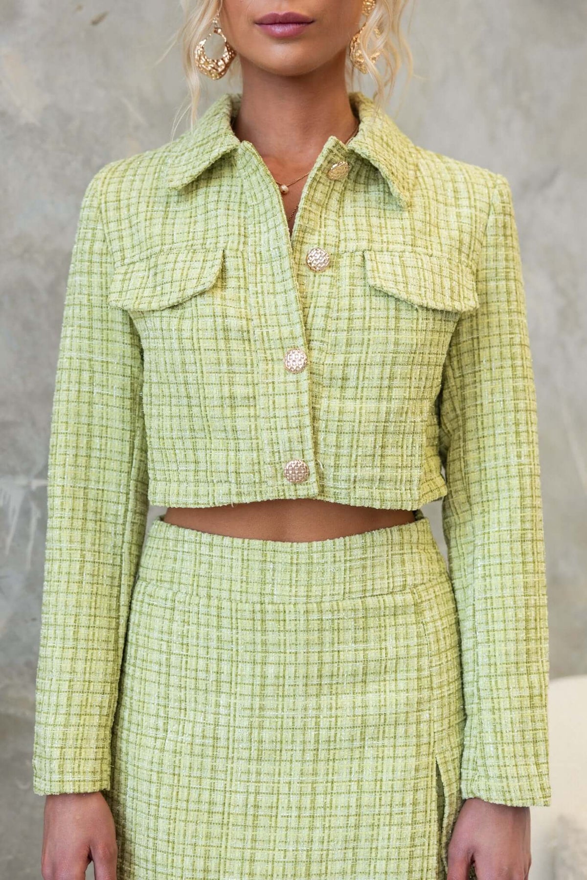 Sophia Coat in green tweed, featuring a collar, faux pockets, and button-up front, styled with matching skirt.