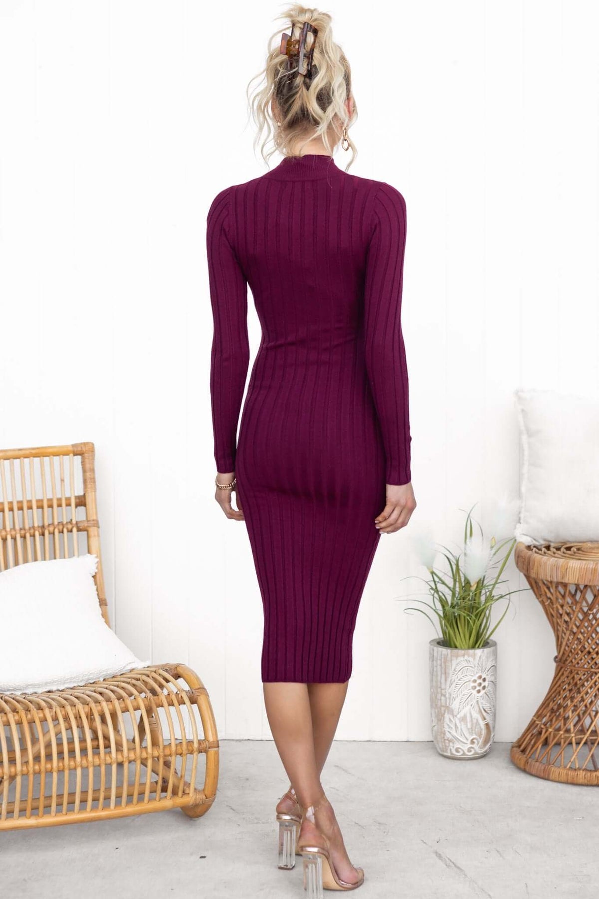 Back view of a model in a burgundy Bonners Midi Dress with ribbed knit, high neckline, and figure-hugging fit.