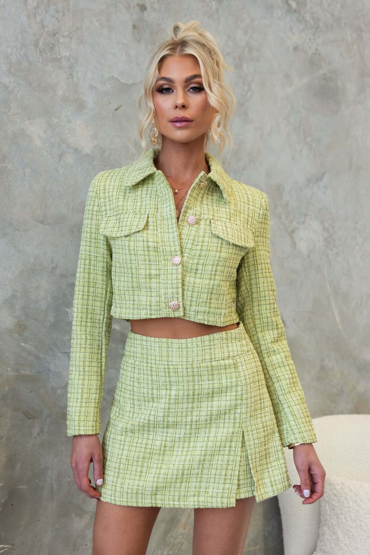 Sophia Coat in light green tweed, featuring a cropped fit, button-up front, and faux pockets, styled with a matching mini skirt.