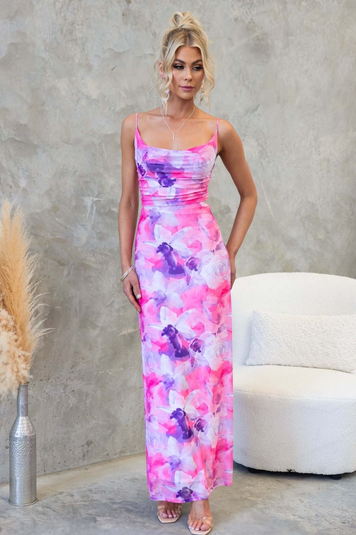 Model showcasing Cranley Maxi Dress, featuring adjustable straps and vibrant pink floral pattern, perfect for summer occasions.