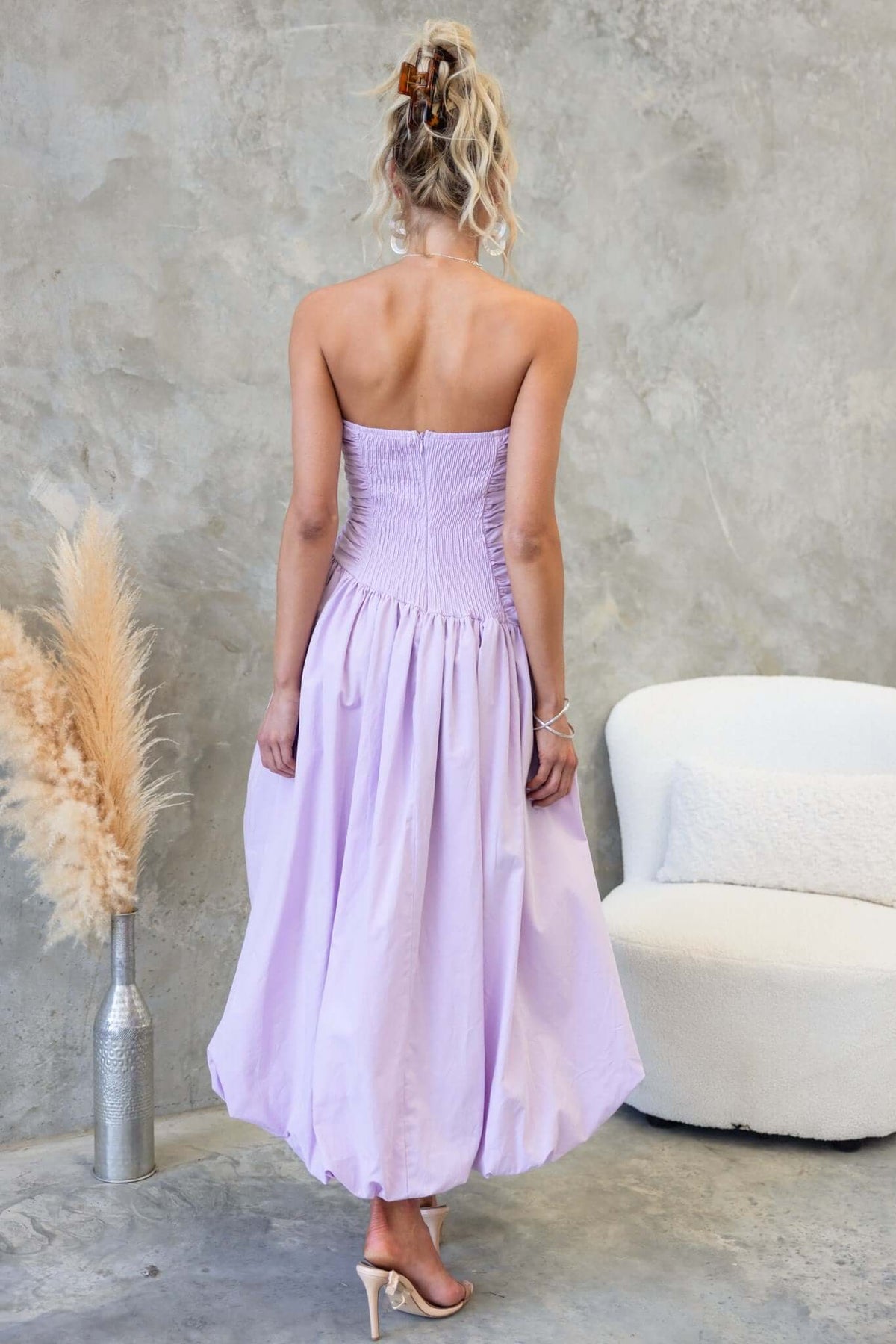 Back view of Carette Midi Dress in lavender, strapless with asymmetric hemline and elastic detailing.