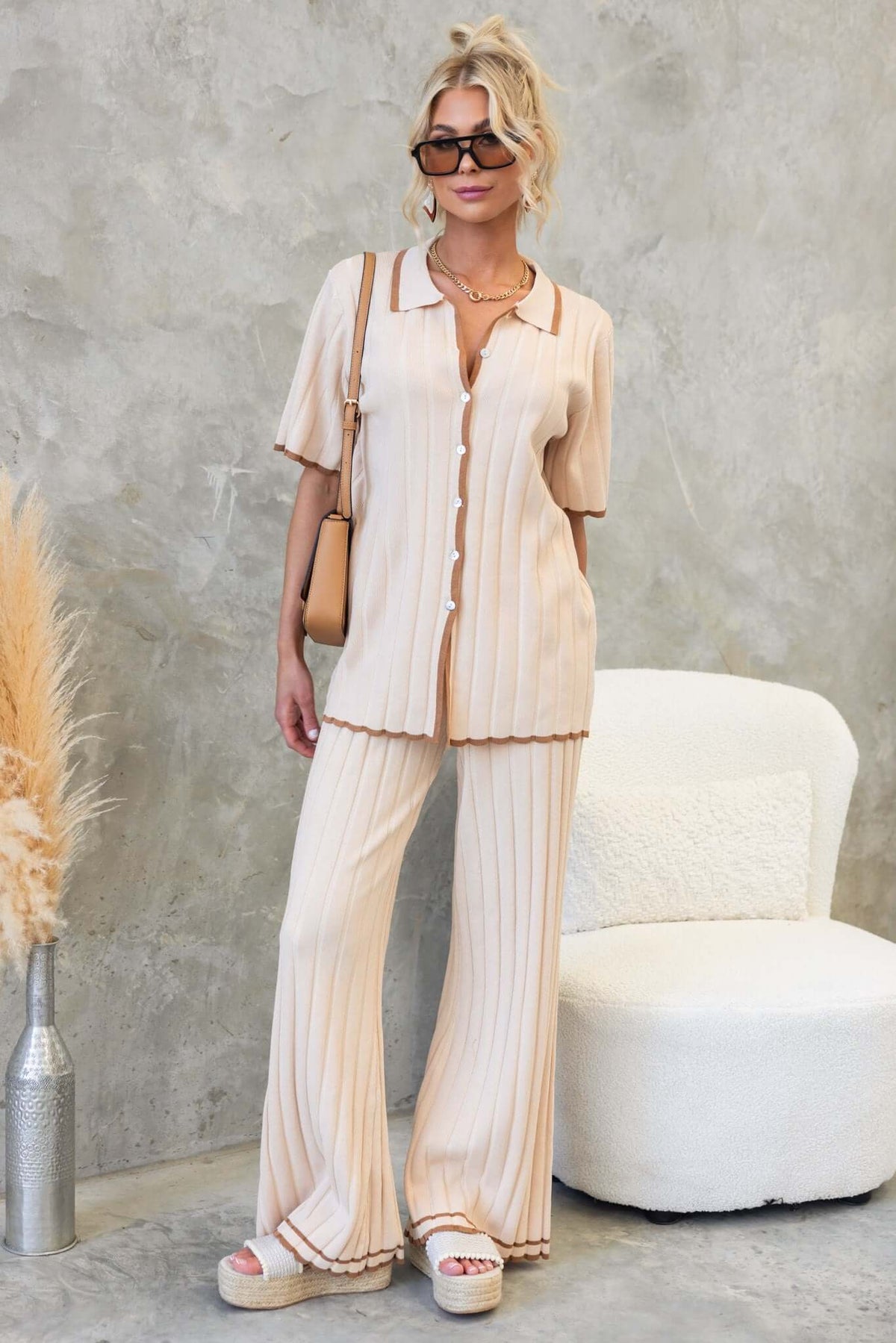 Model wearing Jodie Pants with a matching button-up shirt, featuring a stylish ribbed design and neutral color palette.