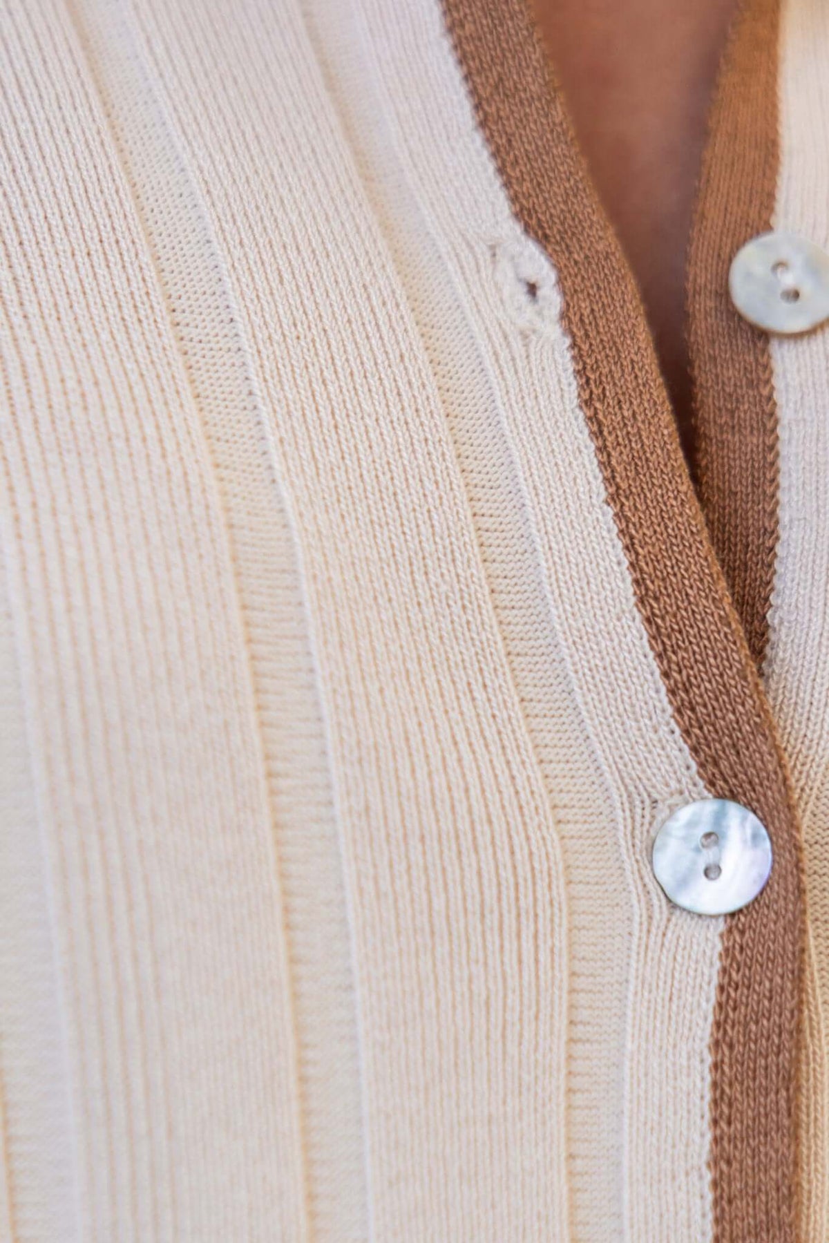 Close-up of ribbed knit Jodie Pants with buttons, highlighting the beige and brown color contrast.