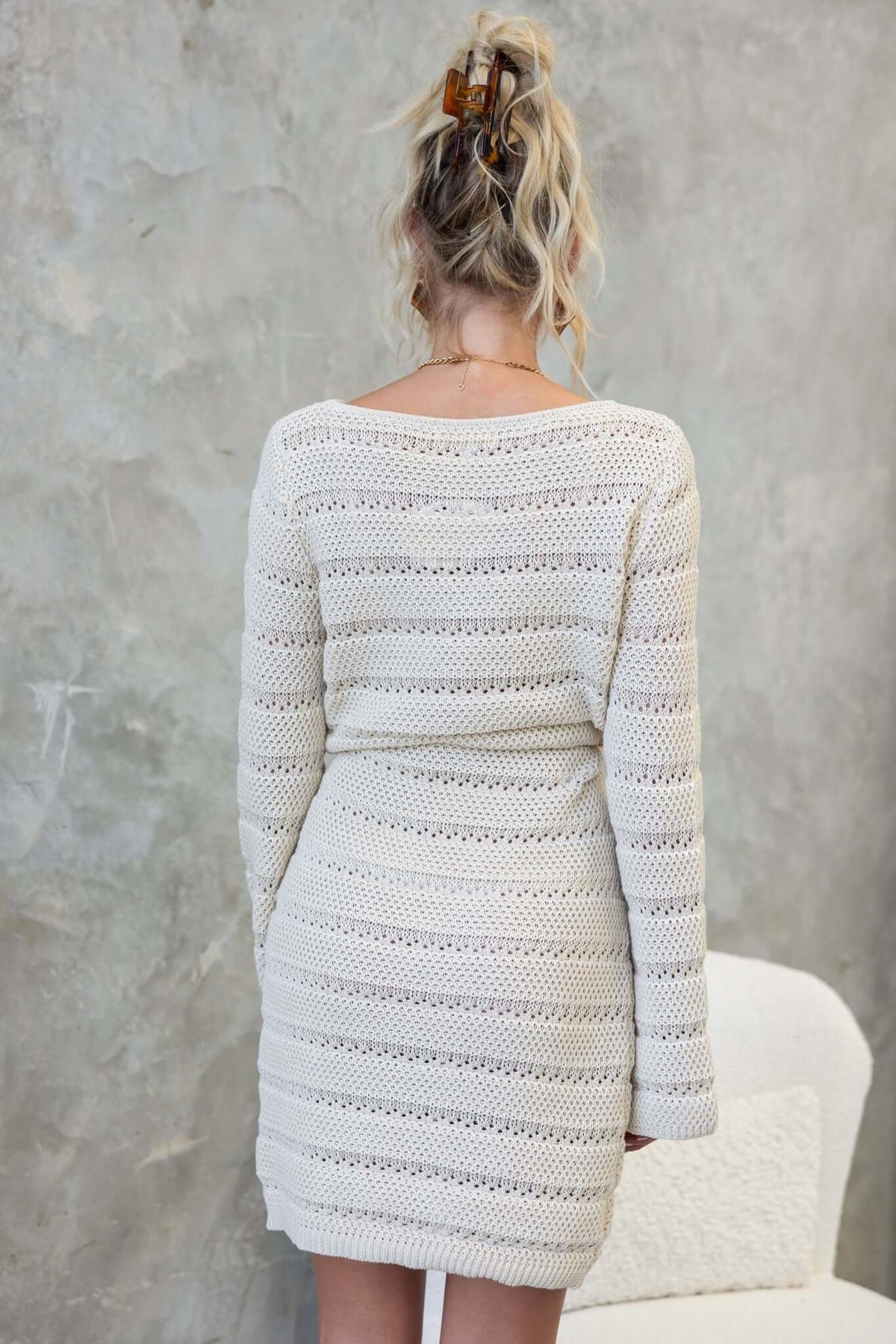 Back view of the Dunne Dress featuring a round neckline and crochet material in a relaxed fit.