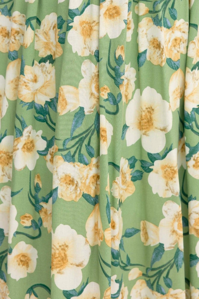 Floral print close-up of Juliette Maxi Dress in green with yellow flowers, showcasing the elegant fabric design.