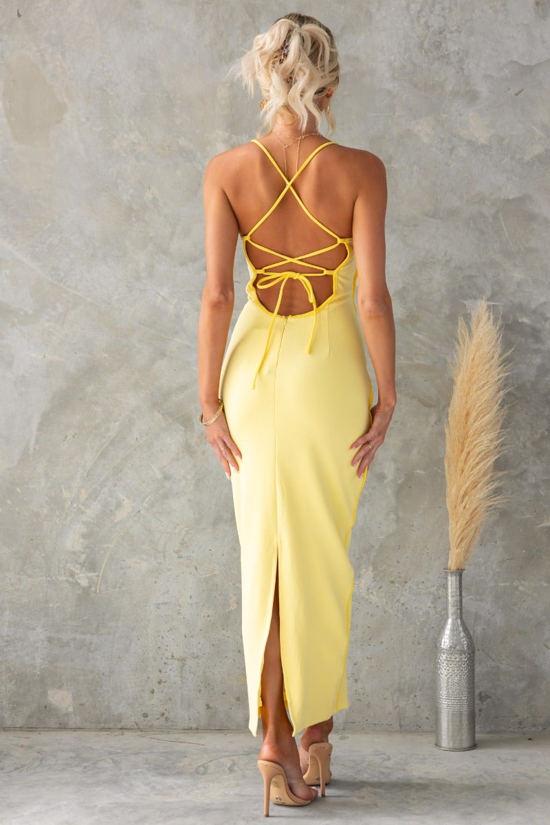 Channing Maxi Dress in yellow with adjustable tie straps and split back detail, perfect for a stylish summer look.