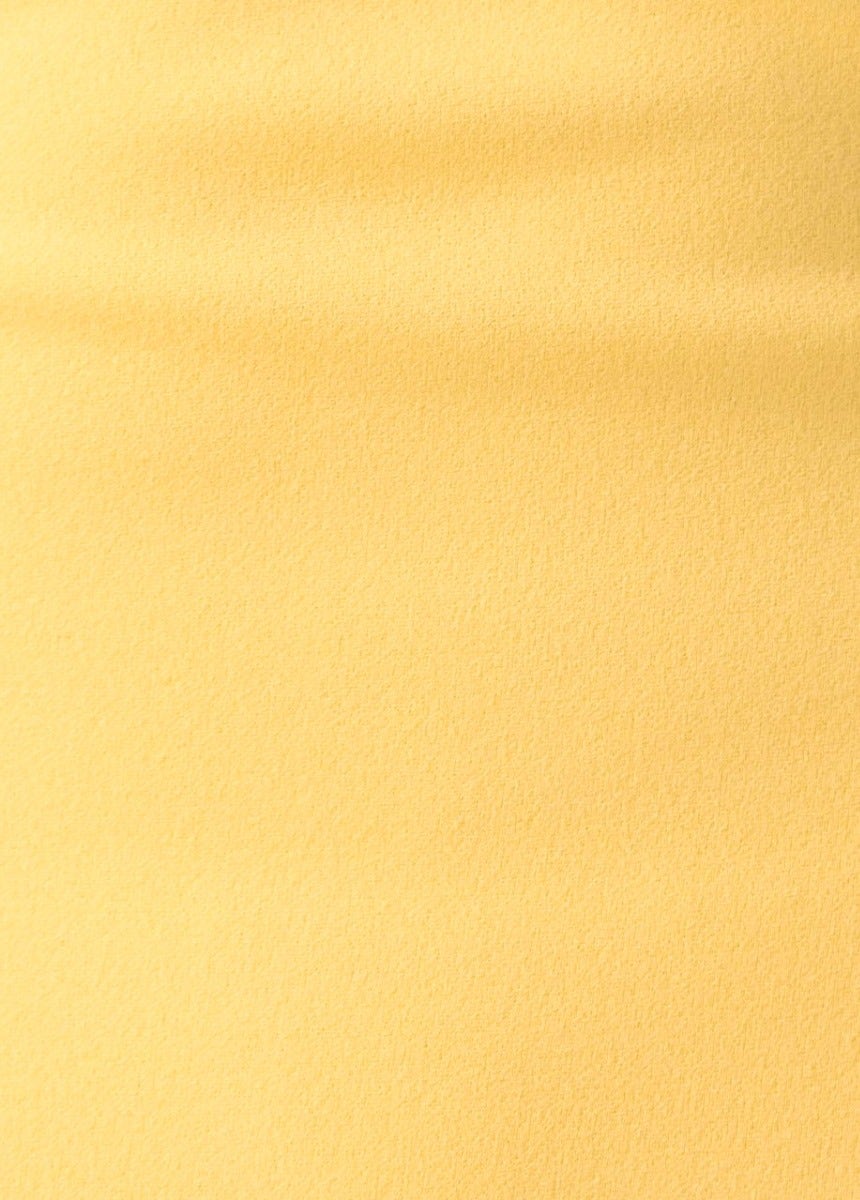 Close-up of soft yellow crepe fabric suitable for a bodycon maxi dress, highlighting its smooth texture.