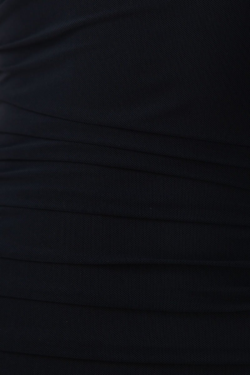 Close-up of textured black material with draped design, showcasing the elegant fabric details of the Formation Midi Dress.
