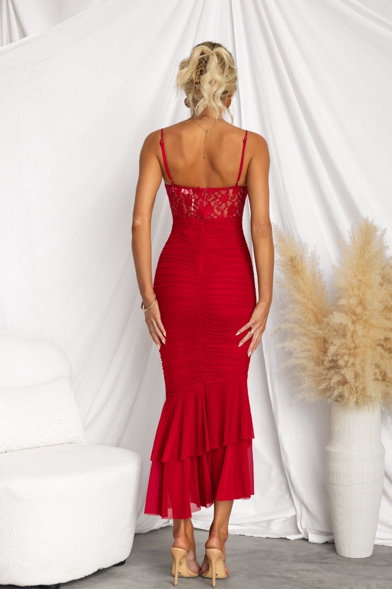 Elegant red bodycon maxi dress featuring lace panel, adjustable straps, and tiered hem.
