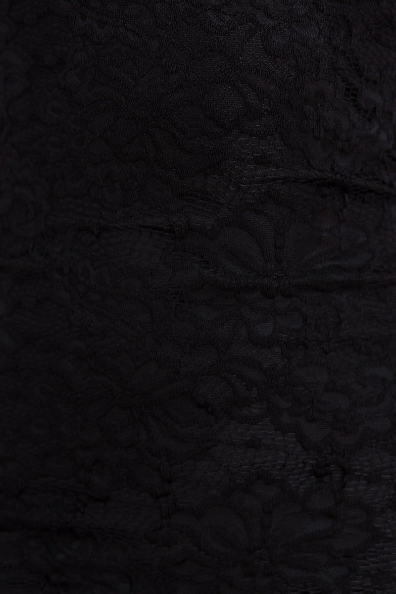 Close-up of black lace fabric texture for the Mesmerise Maxi Dress, featuring intricate floral patterns.