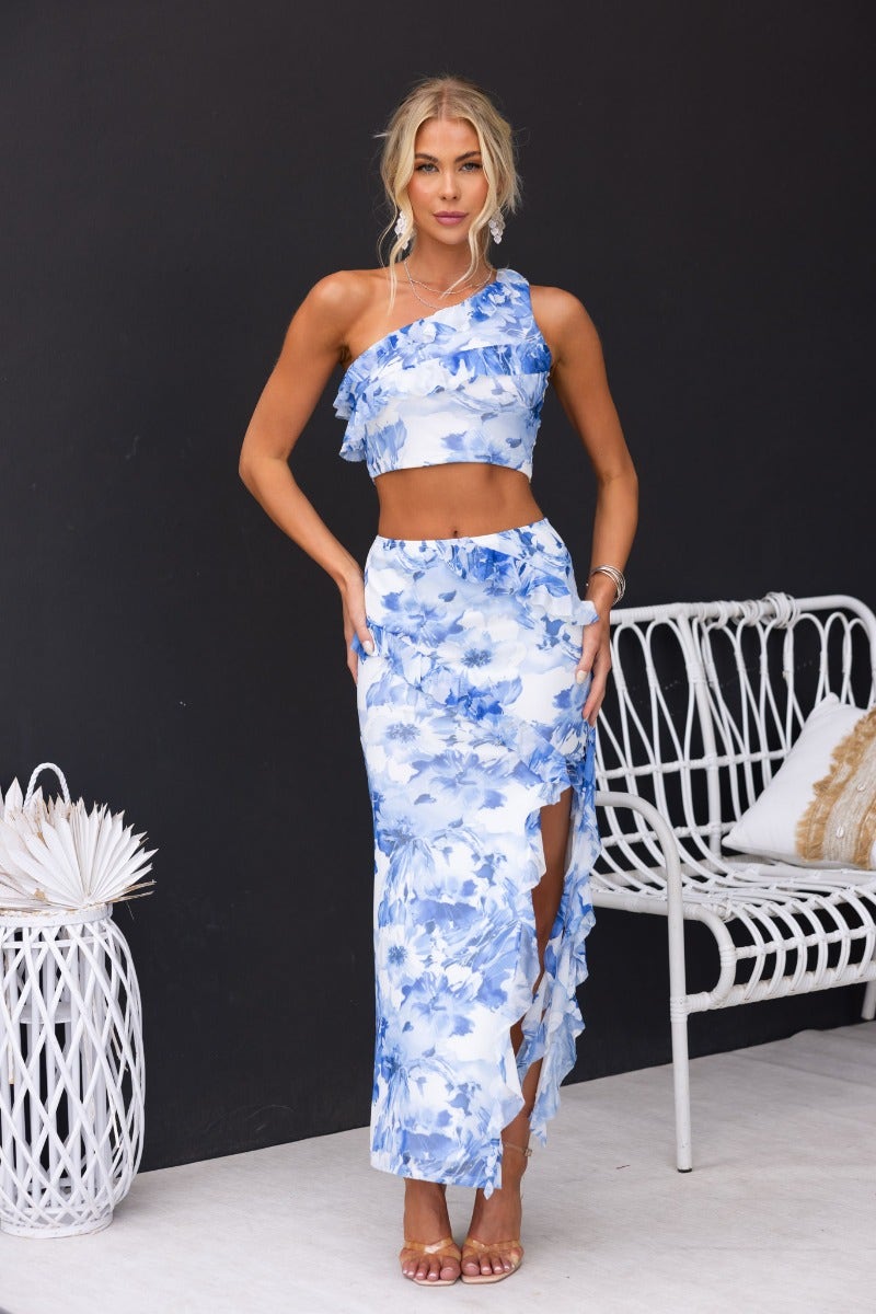 Eyes Closed Maxi Skirt features a floral print, mid-high waist, and ruffle detailing with a side split, perfect for stylish summer wear.