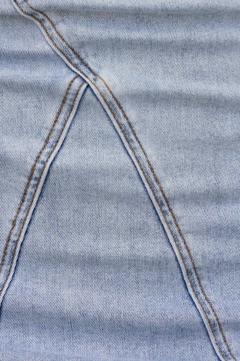 Close-up of structured denim fabric showing detailed stitching on the Weldon Denim Dress.