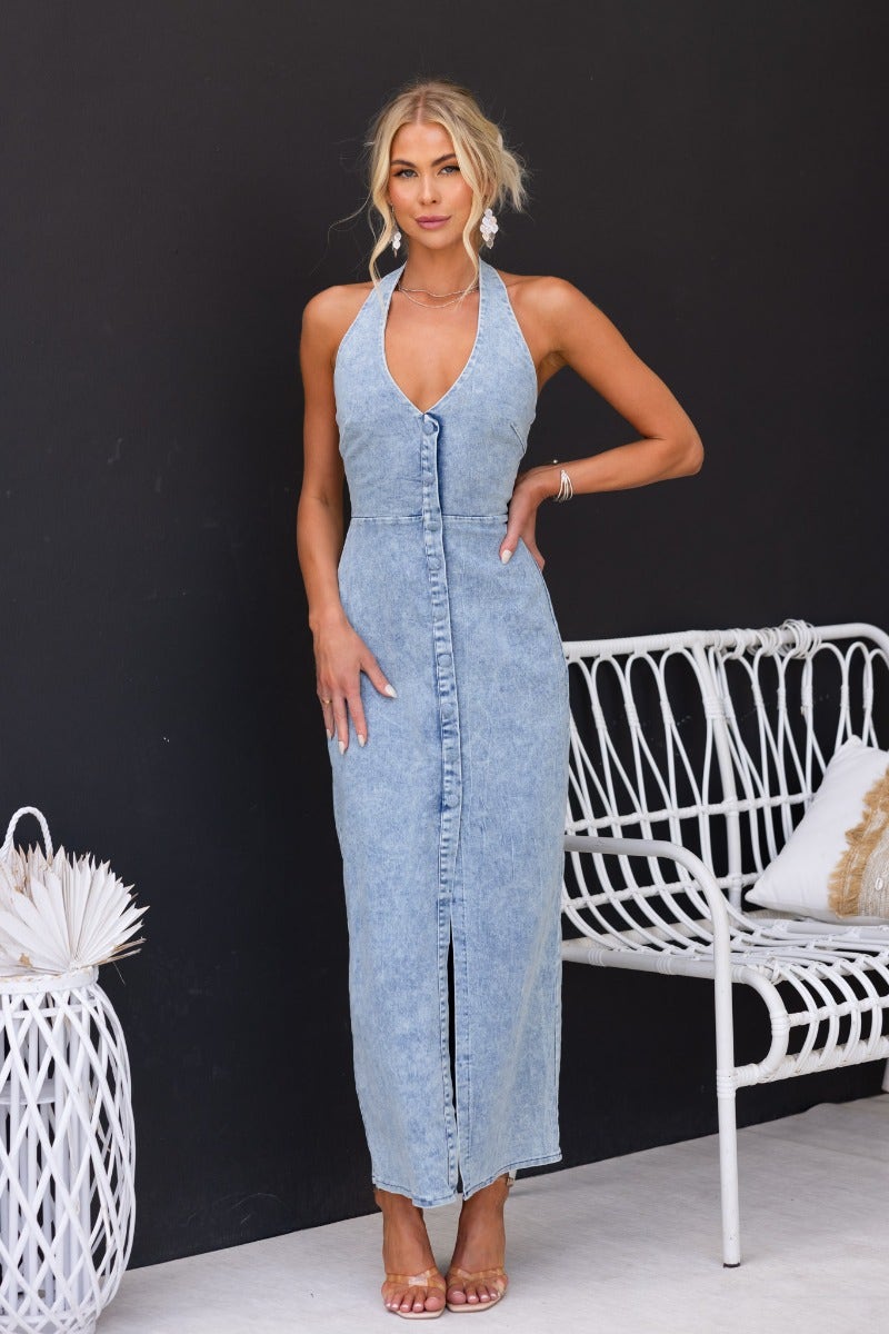 Model wearing Yvette Denim Maxi Dress with halter neckline, faux button-up front, and front split.