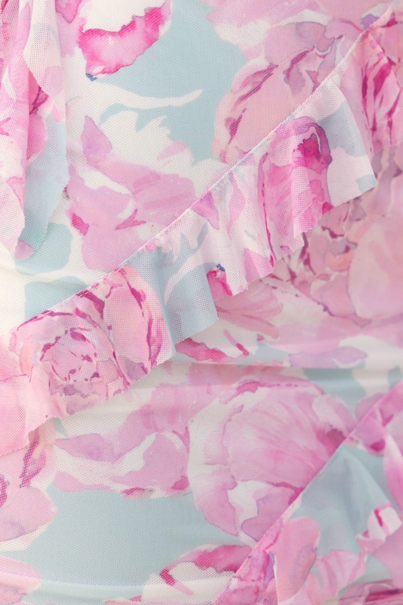 Close-up of the floral ruffle trim on Nelsy Dress in pastel blue and pink, showcasing delicate mesh overlay.