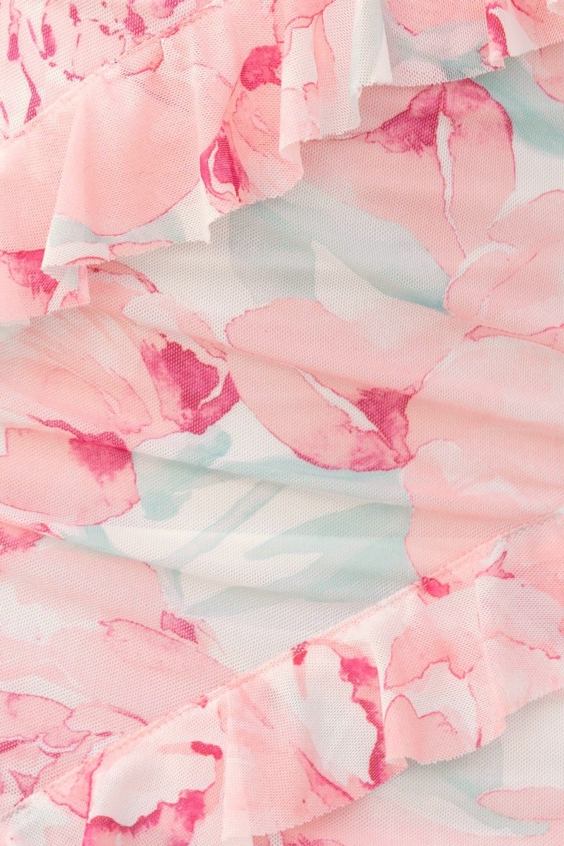 Close-up of Nelsy Dress fabric featuring pink floral ruffle trim and soft mesh overlay.