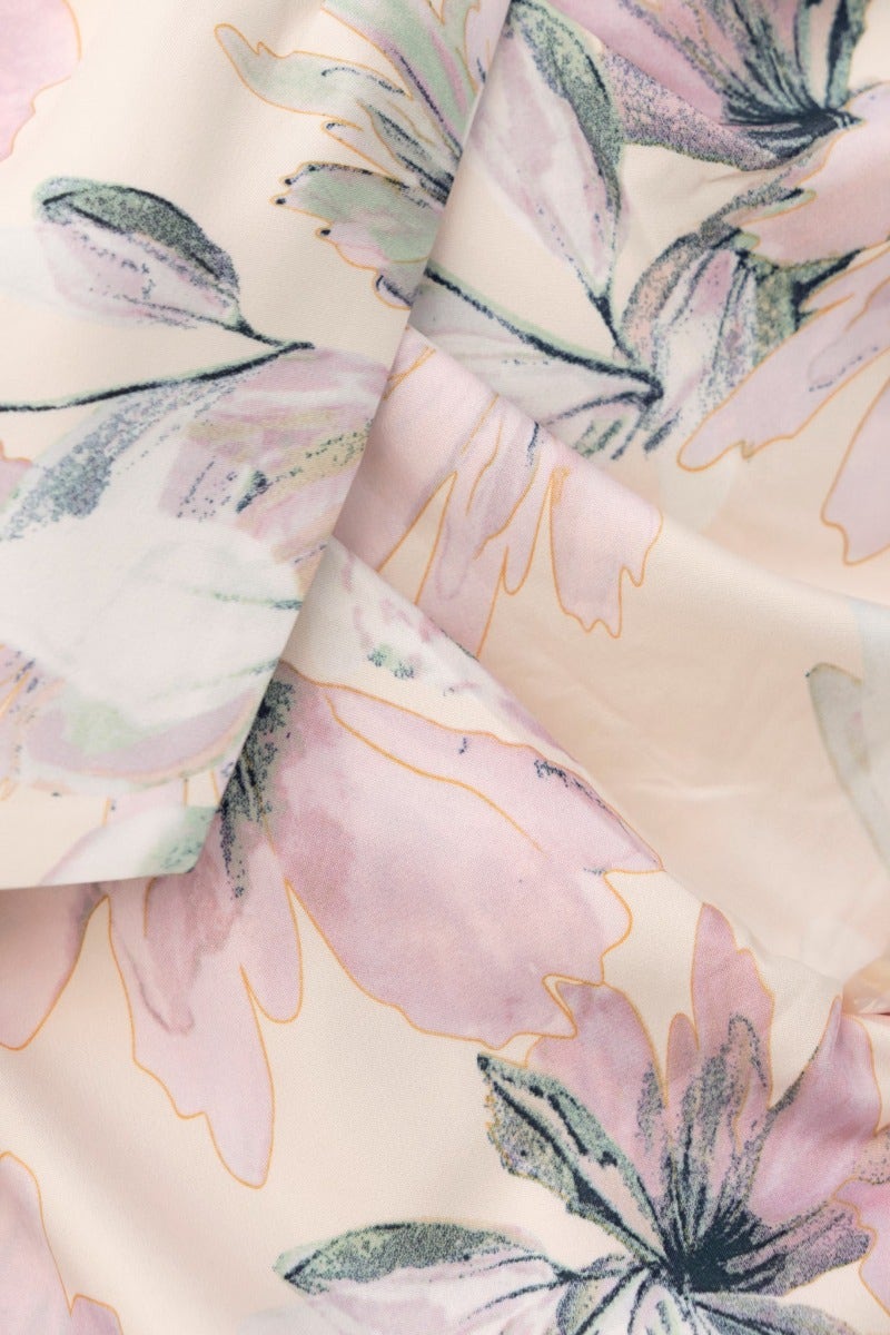 Floral print fabric in shades of pink and green, ideal for a stylish strapless dress.