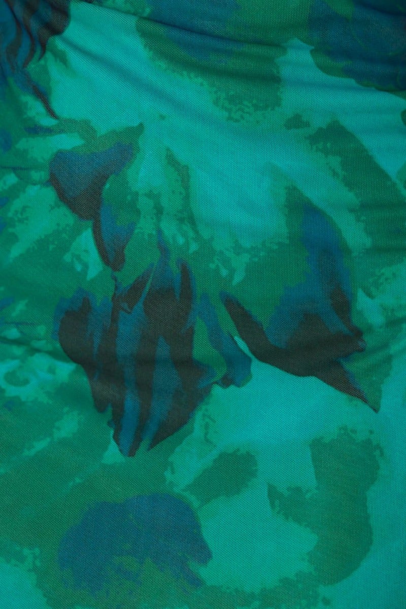 Close-up of abstract teal and green floral pattern on Bad Habits Maxi Dress, showcasing its stylish design.