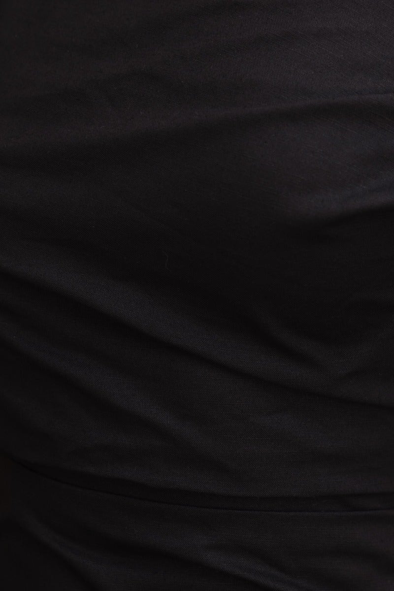 Close-up of the fabric texture of the Annerly Black Maxi Dress, highlighting its sleek and elegant linen look.