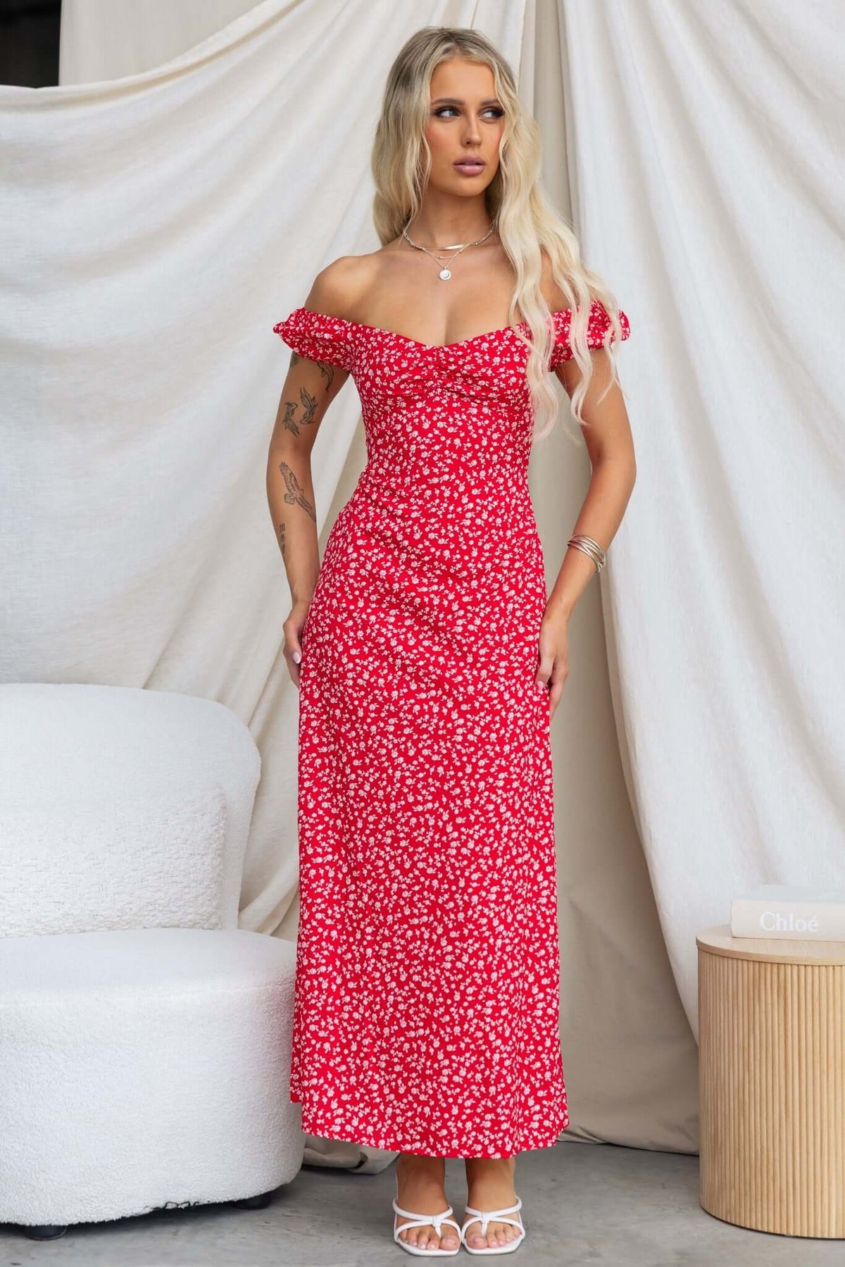 Frankle Maxi Dress in red floral print, featuring off-the-shoulder design and fitted silhouette, perfect for summer outings.