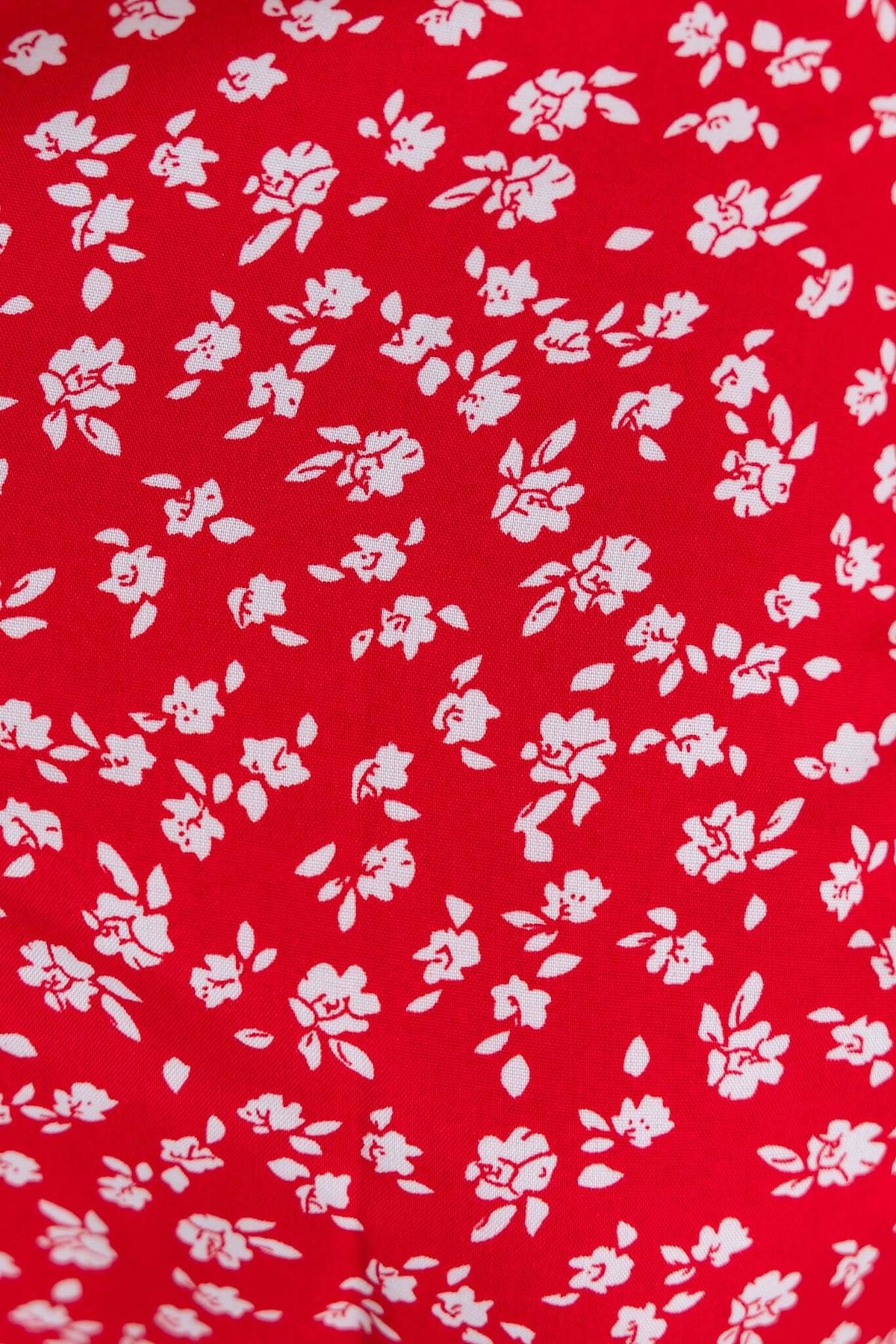 Red floral fabric pattern featuring white flowers, perfect for a vibrant maxi dress design.