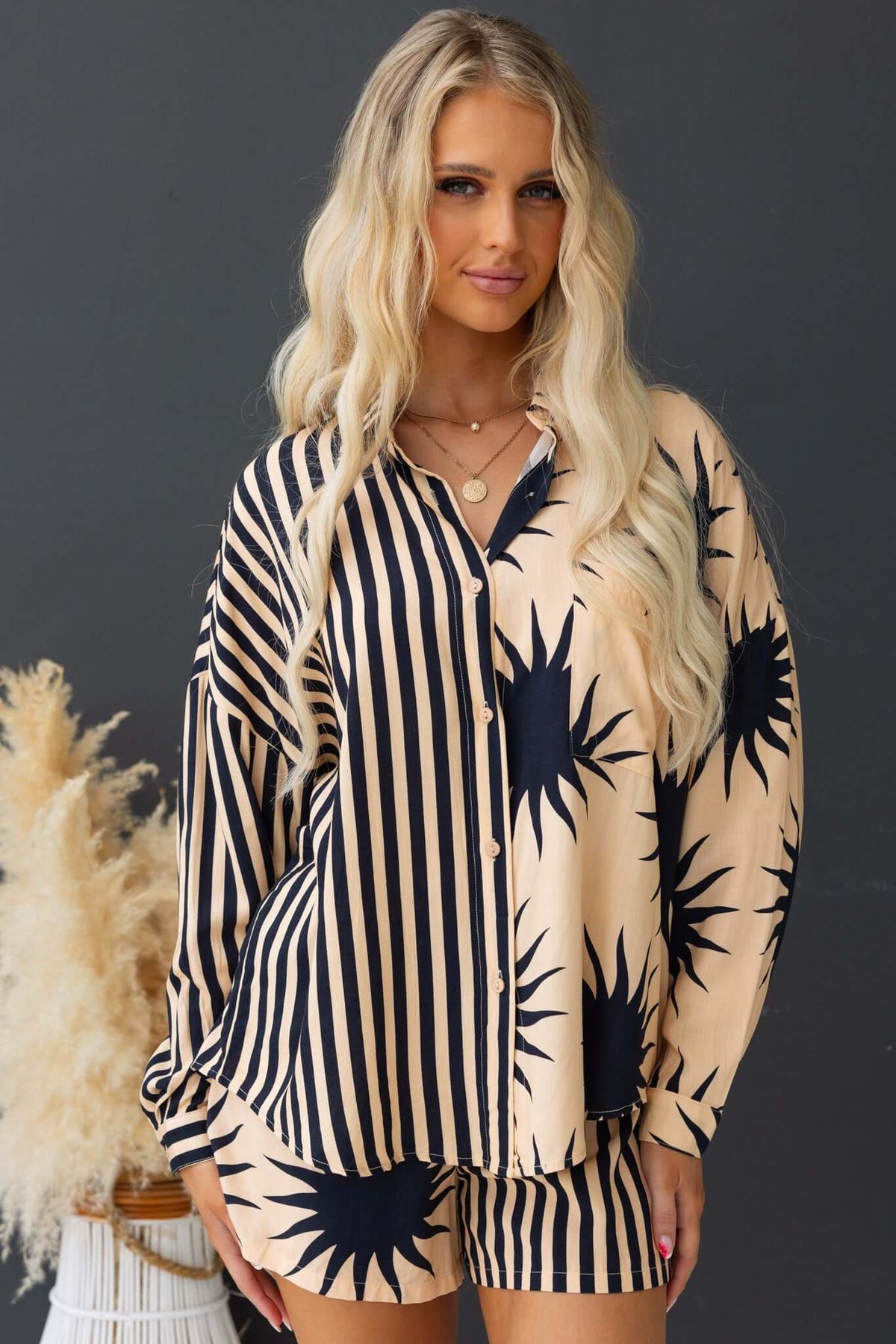Hadley Shirt featuring a button-up front, collar, and sunburst print, styled in relaxed fit with shorts.