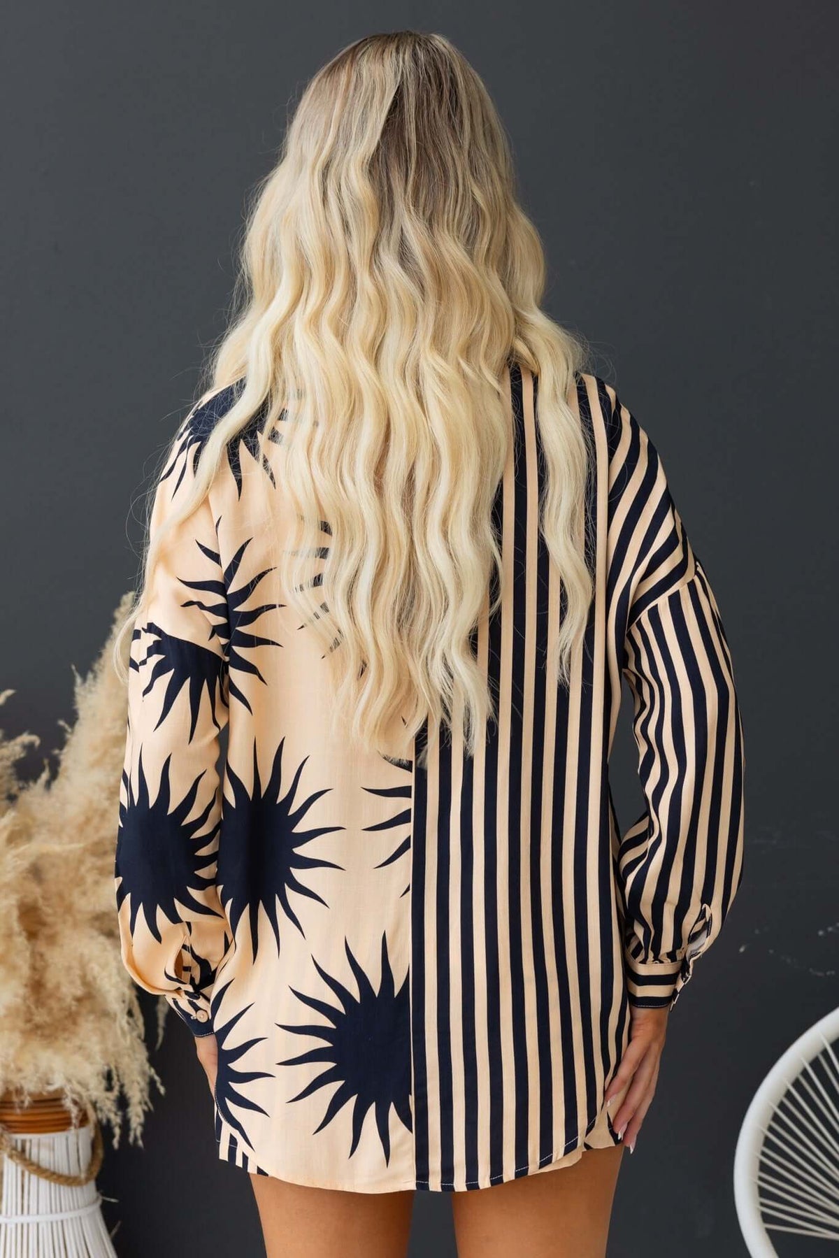 Back view of the Hadley Shirt featuring a mix of sunburst and striped patterns, styled casually.