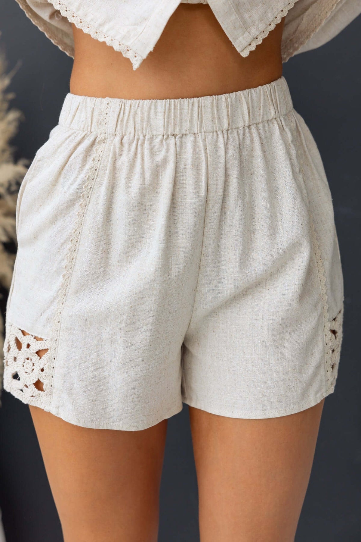 Rayner Shorts featuring mid-high waist, elastic waistband, and crochet detailing in a relaxed fit.