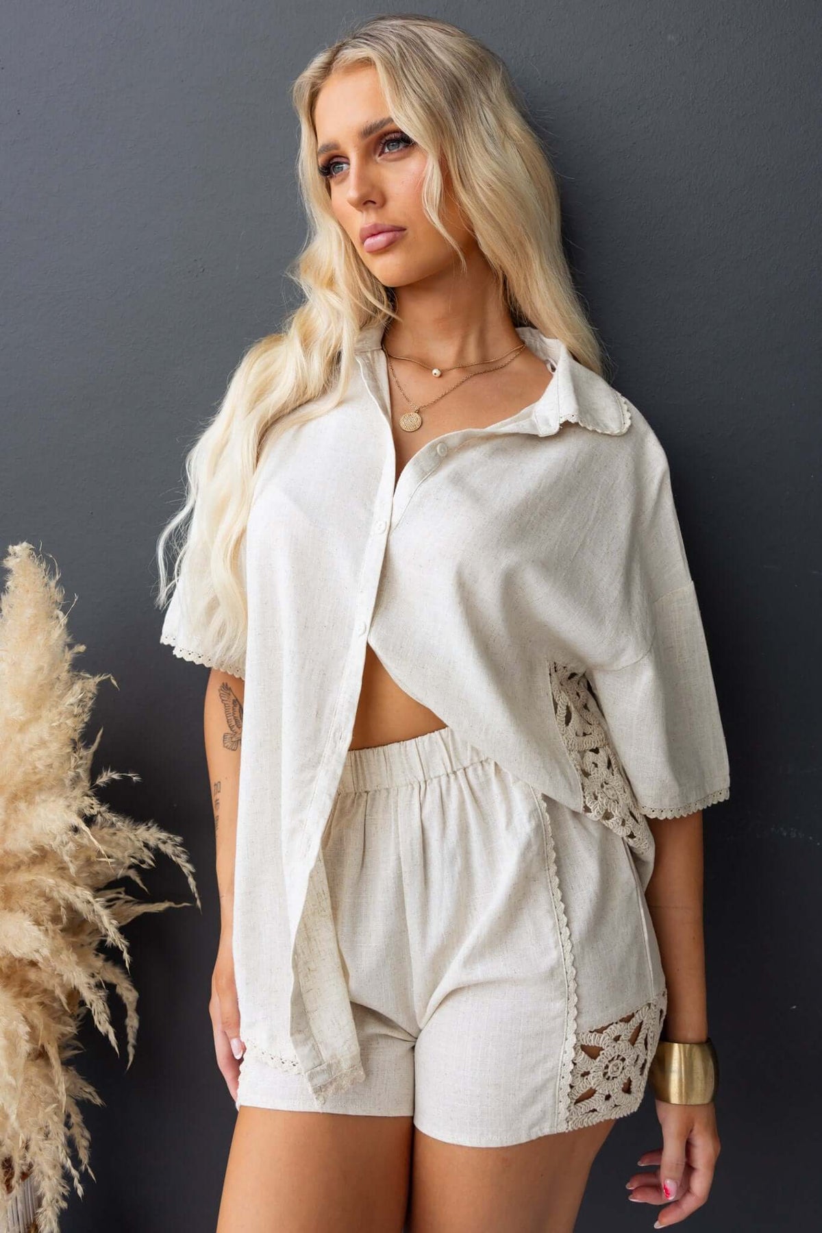 Model wearing Rayner Shorts with crochet detailing, styled with a relaxed shirt, showcasing a mid-high waist fit.