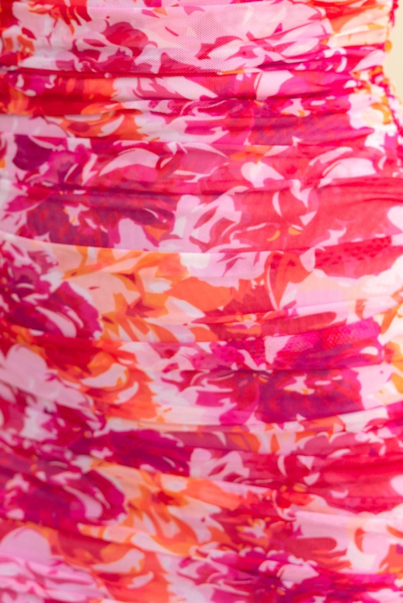 Close-up of Live It Up Dress featuring a vibrant pink and orange floral mesh overlay and ruched detailing.