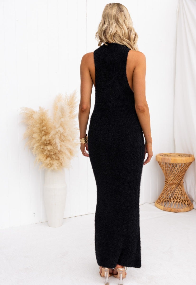 Back view of a black fluffy knit maxi dress with high neckline, showcasing a slightly oversized fit and stretchy material.