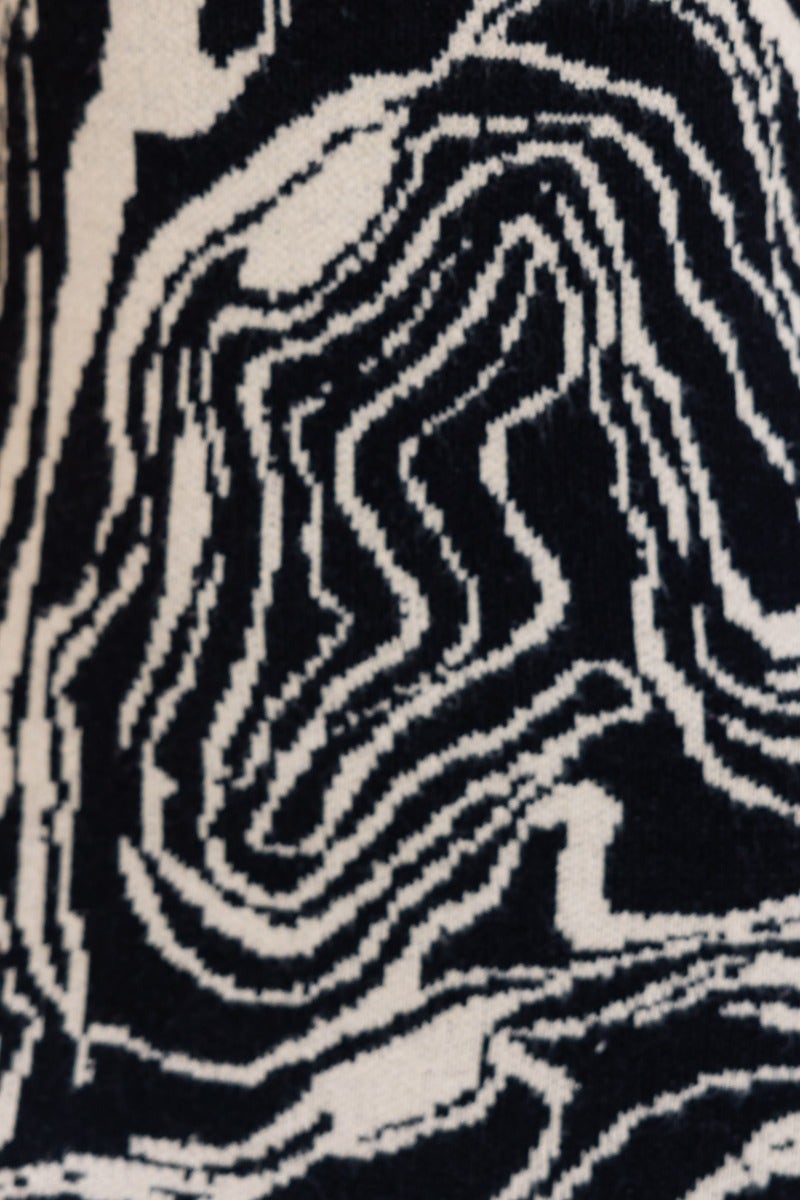 Black and white abstract fabric pattern of a hypnotising maxi dress, showcasing a wavy design.