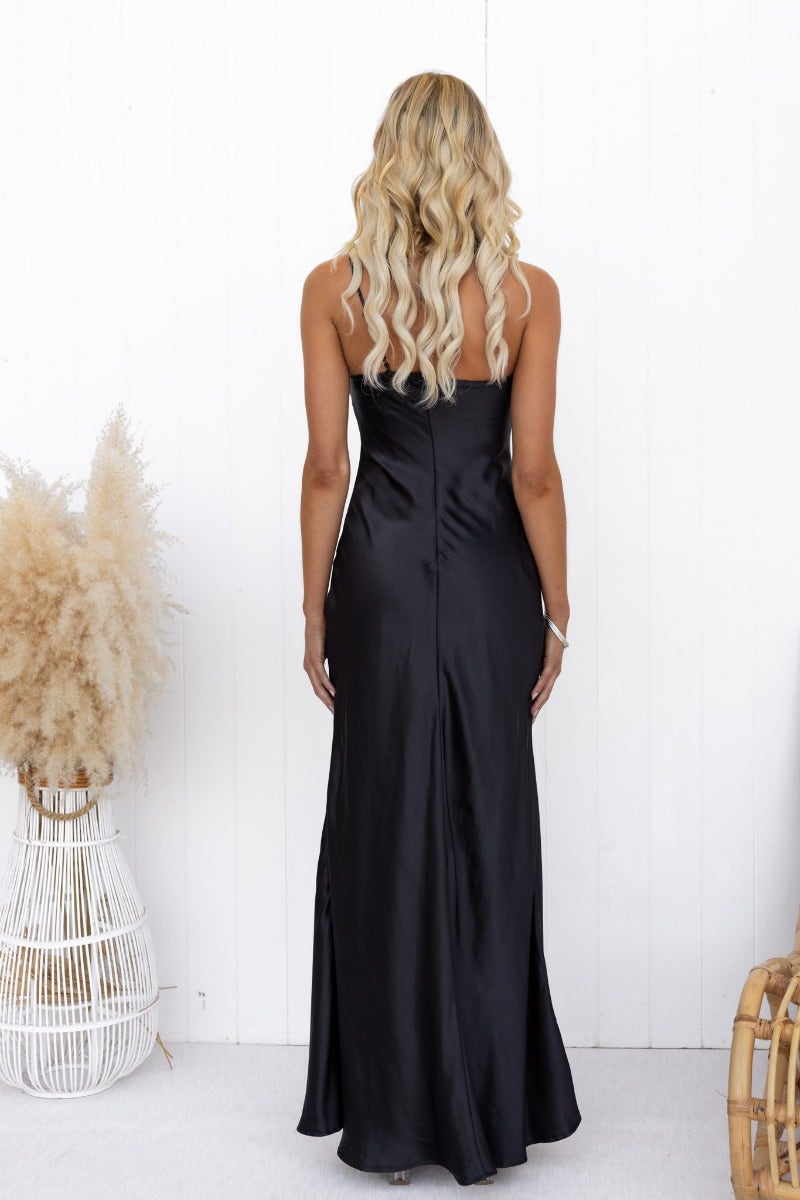 Back view of elegant black satin Ellisia Maxi Dress with one-shoulder neckline and adjustable strap.