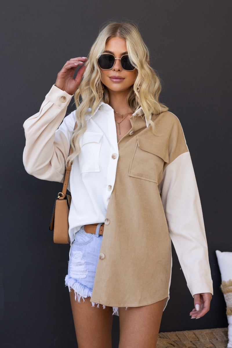 Model wearing Baxter Shirt, a stylish cotton button-up with two-tone design and pockets, paired with denim shorts.