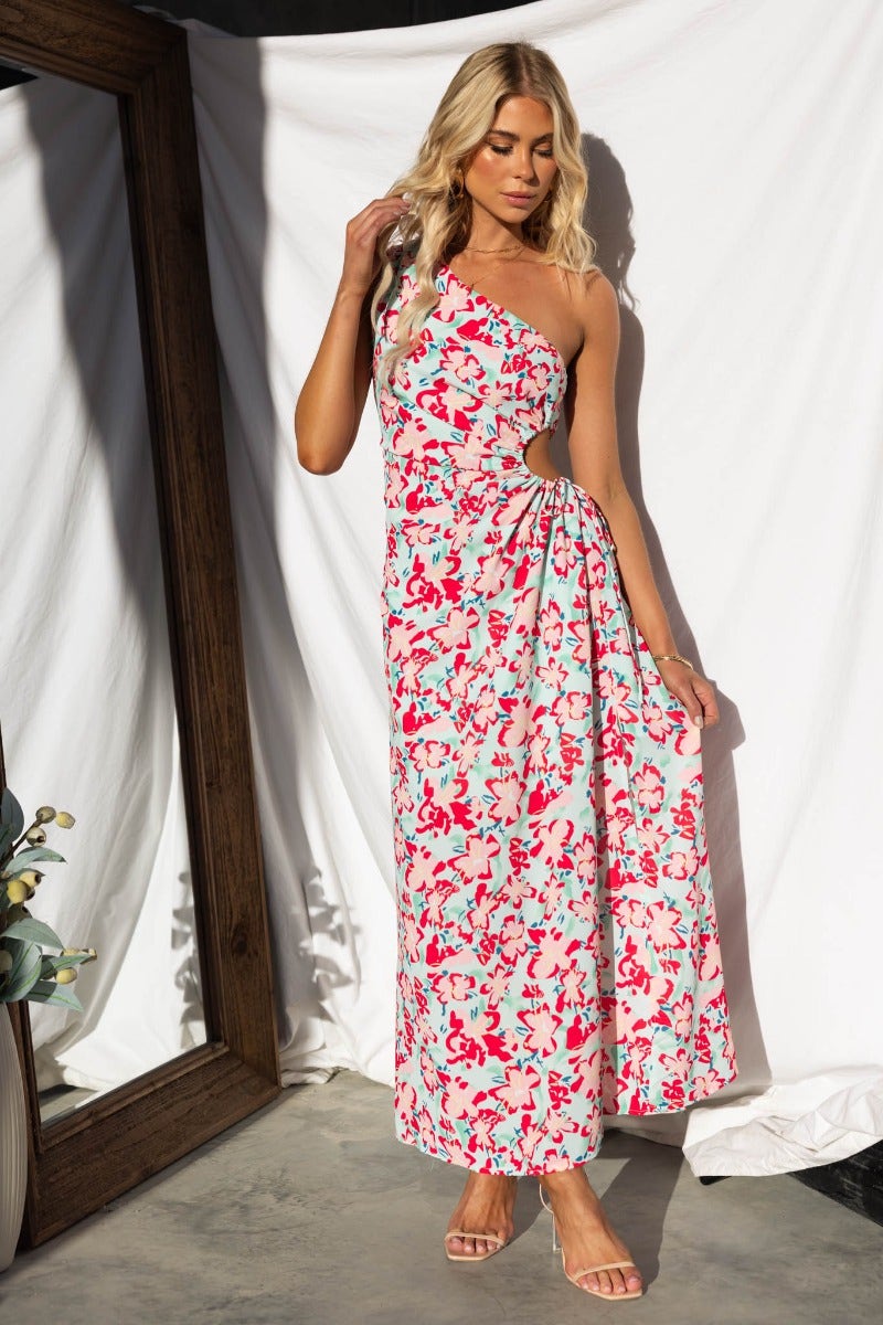 One-shoulder floral print maxi dress with side cut-out and adjustable ruching, perfect for summer occasions.