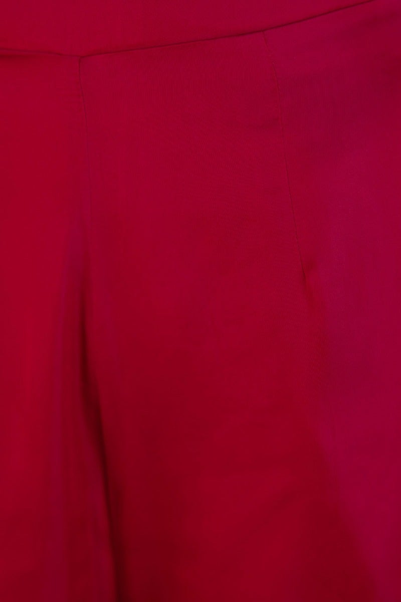 Close-up of the Show Stopper Pants in vibrant red satin, featuring a wide-leg design and an invisible zip.