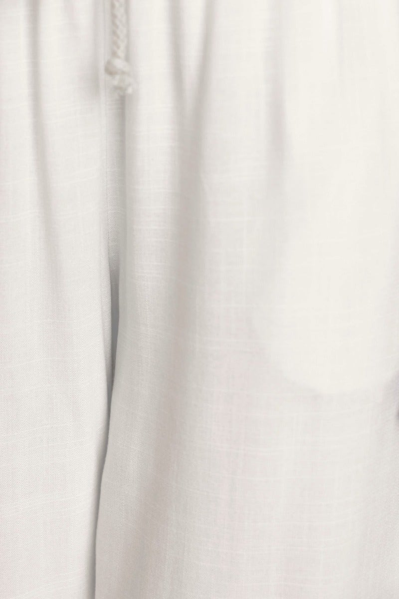 Close-up of Corella Pants in light fabric, featuring a drawstring waist and relaxed fit for comfort.