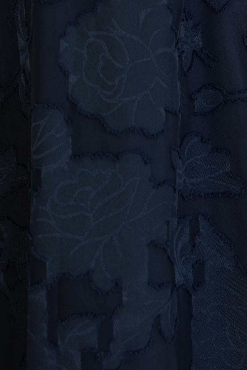 Close-up of embossed navy fabric featuring a floral design, ideal for the Narella Midi Dress.