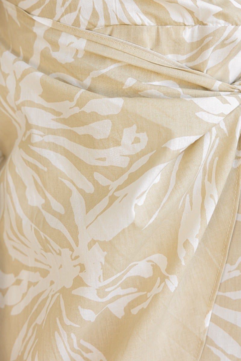 Close-up of floral print fabric from the Take Chances Dress, featuring a beige and white design.