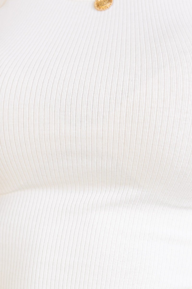 Close-up of Jett Top, a ribbed white tee with round neckline, showcasing stretchy cotton material.