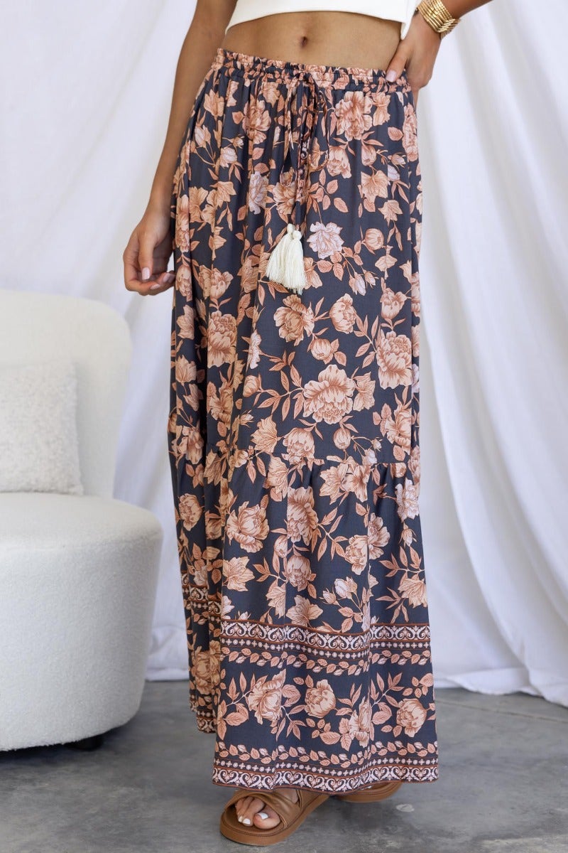 Qorri Maxi Skirt featuring navy floral print, elastic waistband, and side splits, perfect for a stylish summer look.