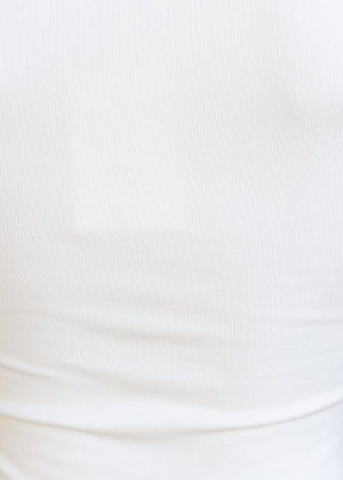 Close-up of a white cotton top with a square neckline and crop fit, showcasing its smooth texture and lined design.