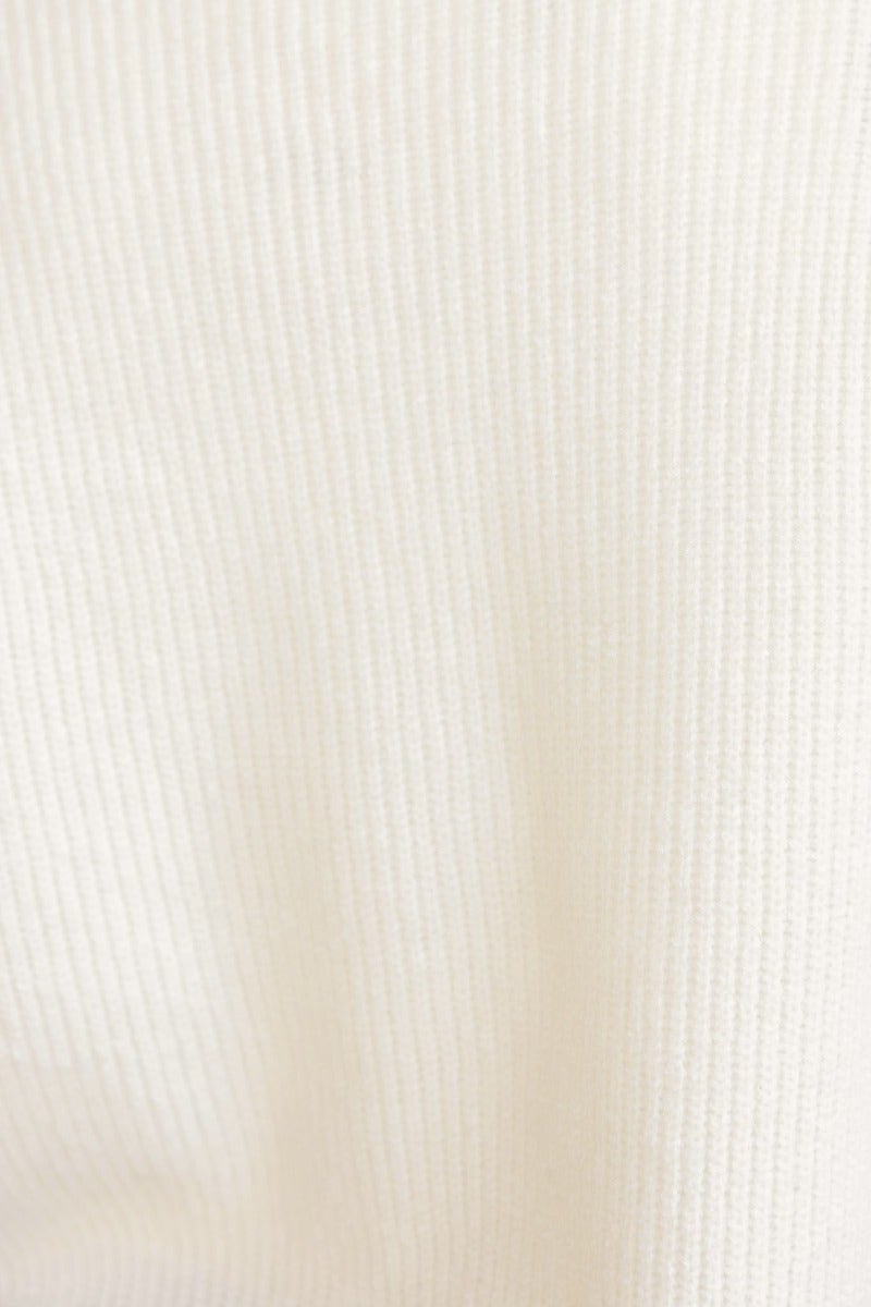 Close-up of the textured fabric of the Gino jumper in a soft, off-white color.