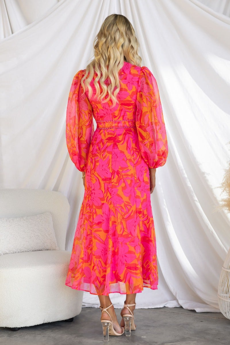 Back view of Zaida Midi Dress in vibrant floral print, featuring puff sleeves and a flowing silhouette.