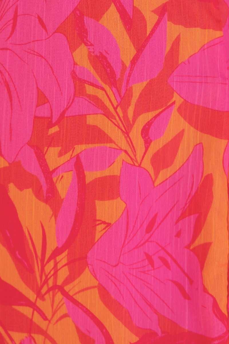 Vibrant floral print in pink and orange hues featuring large leaves and blooms, ideal for Zaida Midi Dress.