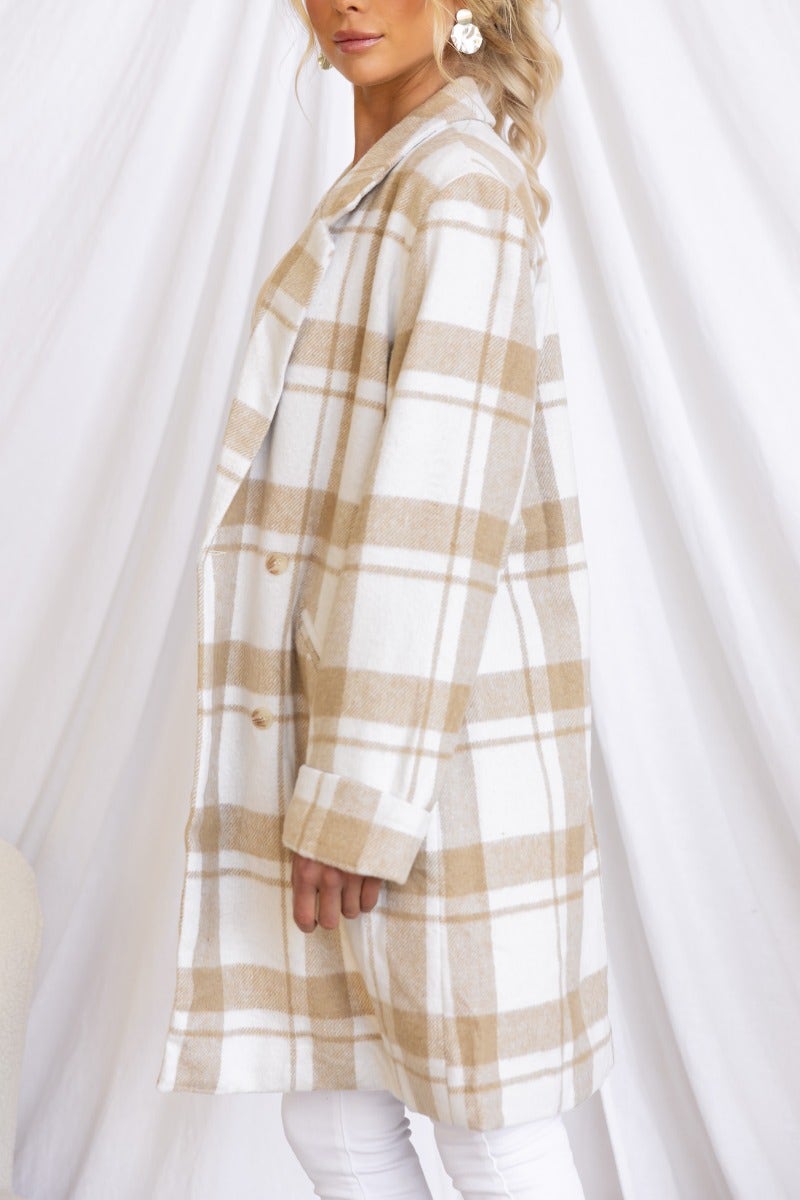 Plaid print Sabine coat with collar, lapel, and button closure, displayed on a model in a stylish and elegant setting.