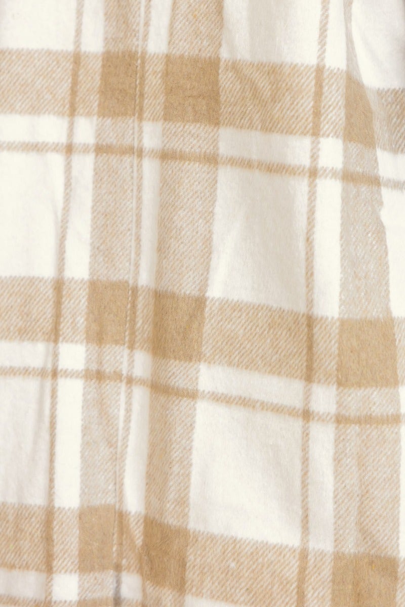 Close-up of plaid print fabric in cream and beige, showcasing the texture and pattern details of the Sabine Coat.